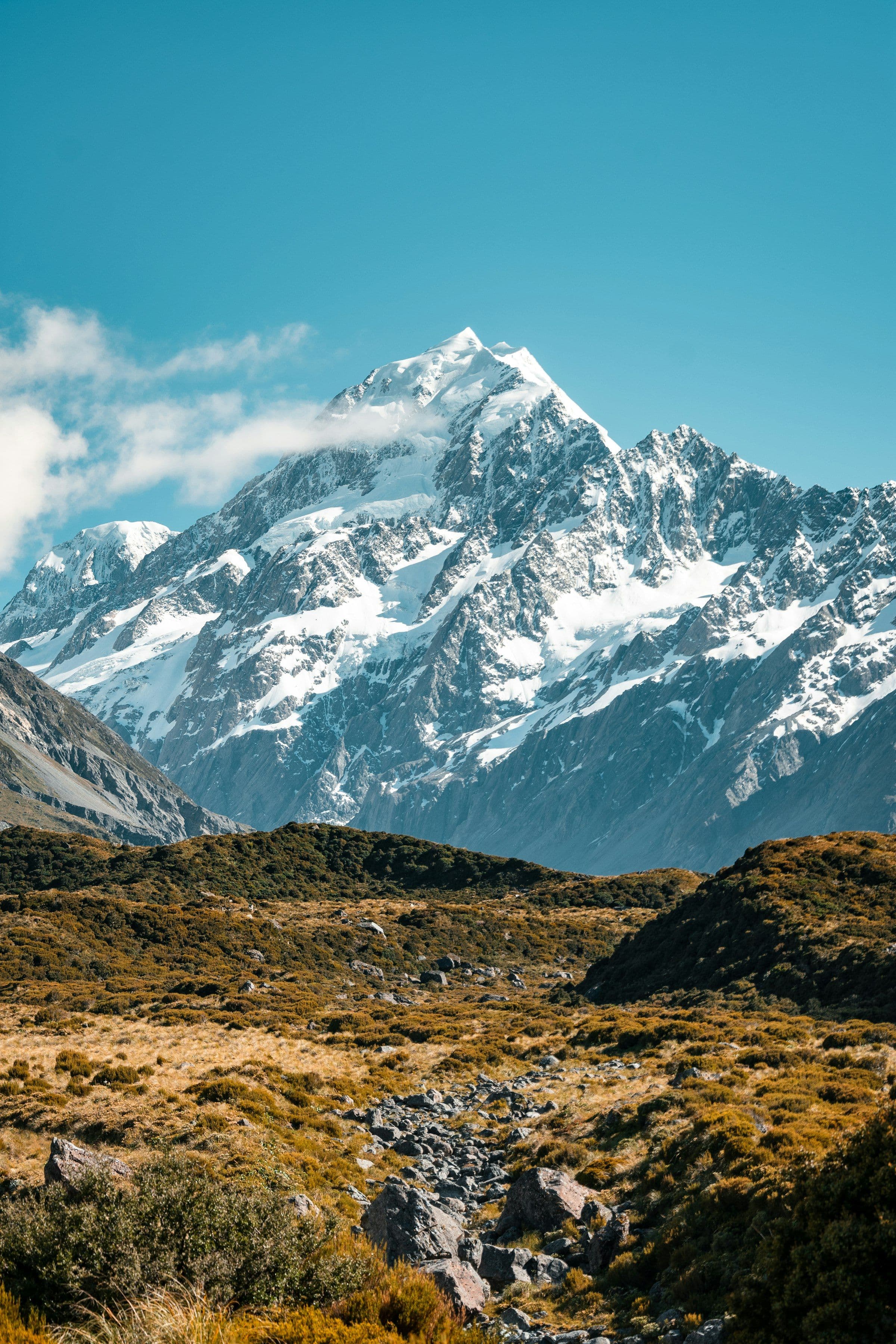 Snow peak above a dry alpine valley