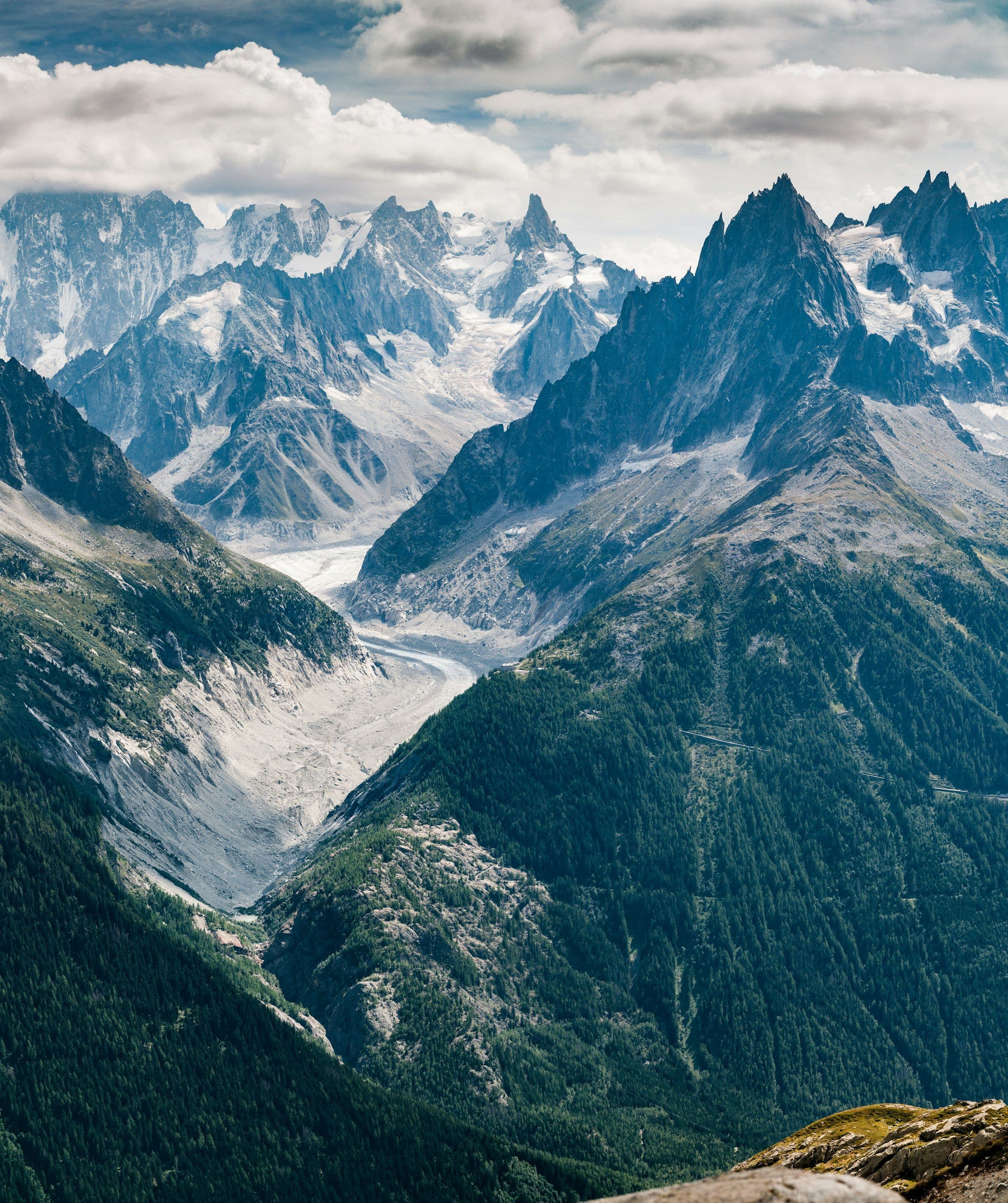 Glacier descending a valley between granite spires
