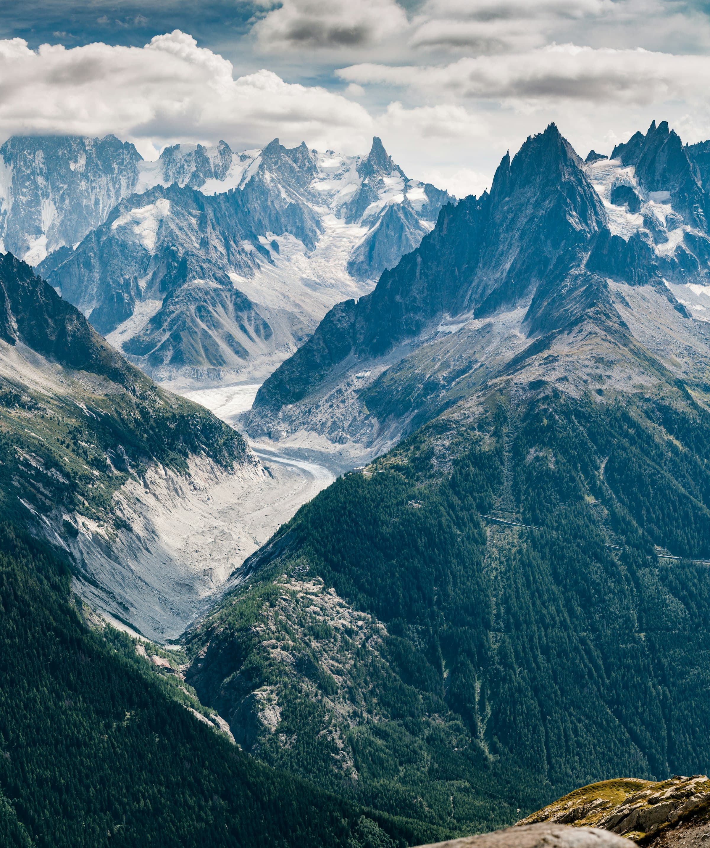 Glacier descending a valley between granite spires