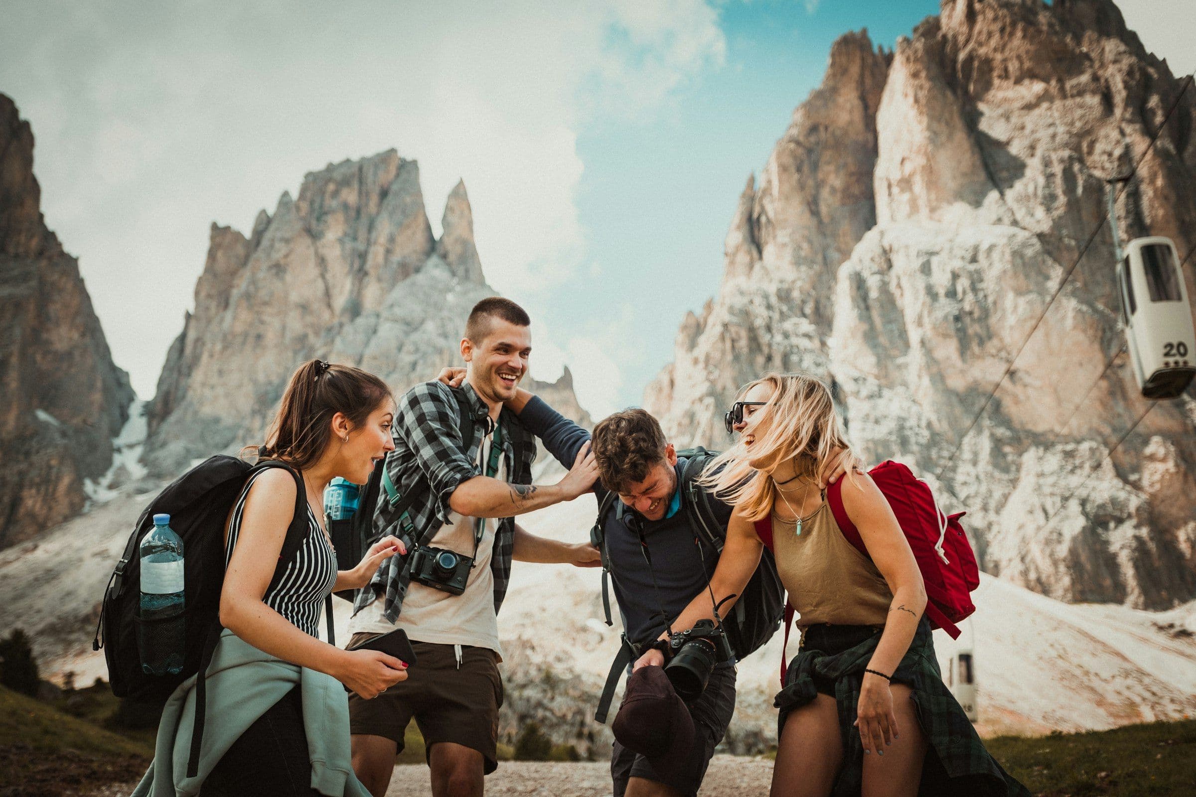 Trekking group laughing together on a rocky pass