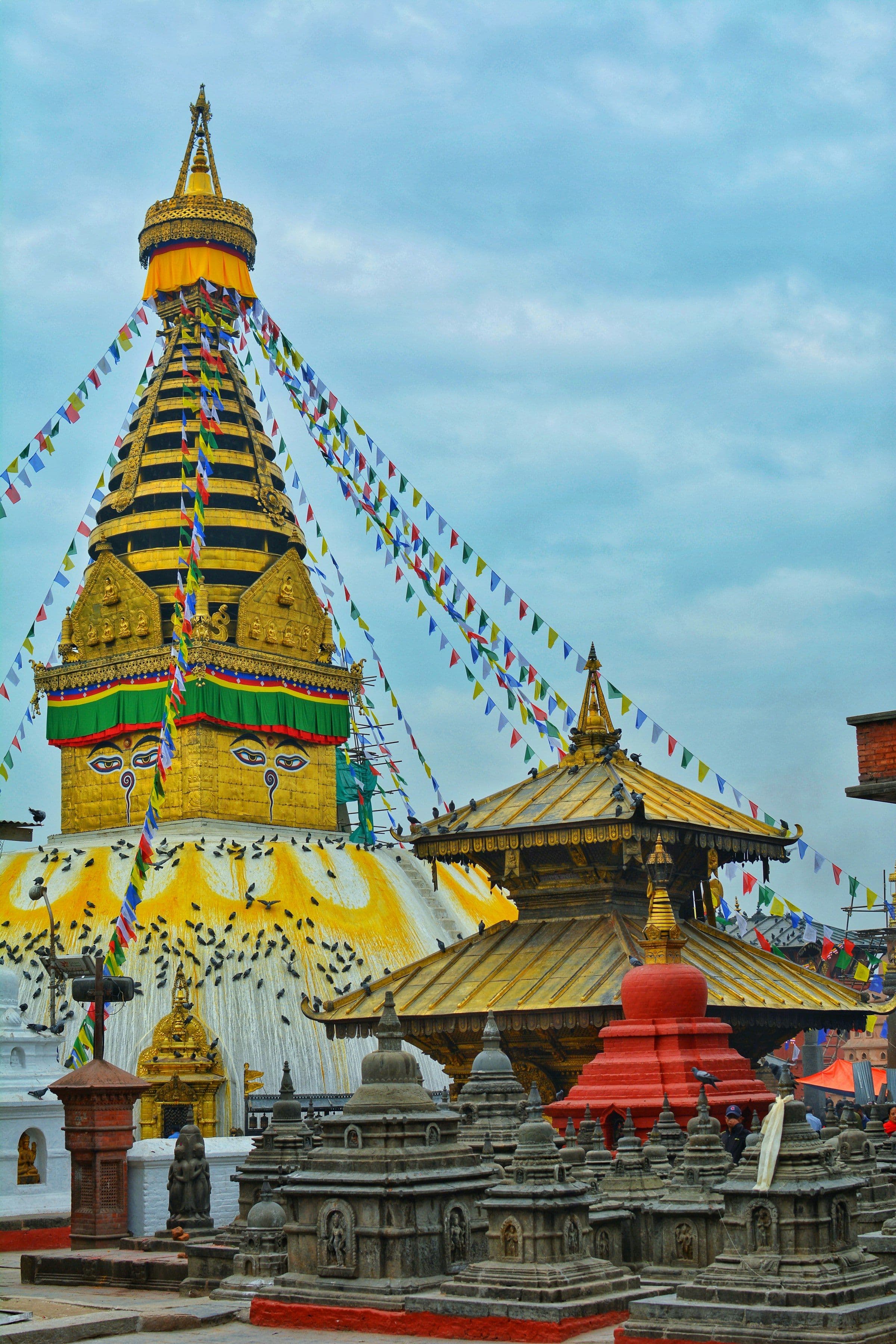 Prayer flags strung over the white dome of Swayambhunath stupa